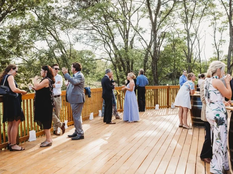 Guests mingling on the deck at Land O' Goshen during cocktail hour