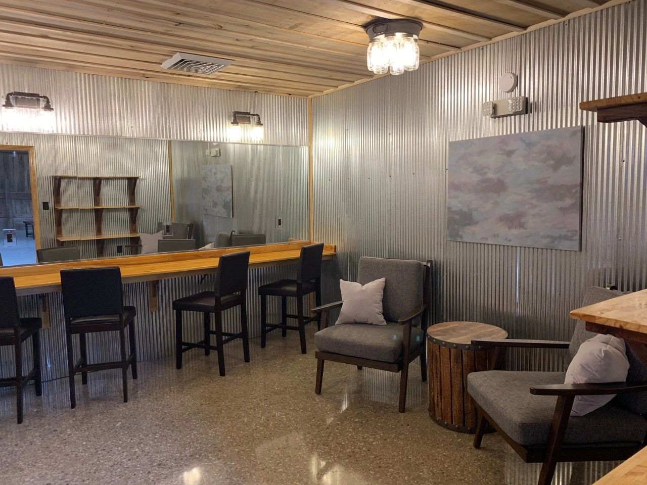 The bridal suite with a long makeup bar, chairs and shelves